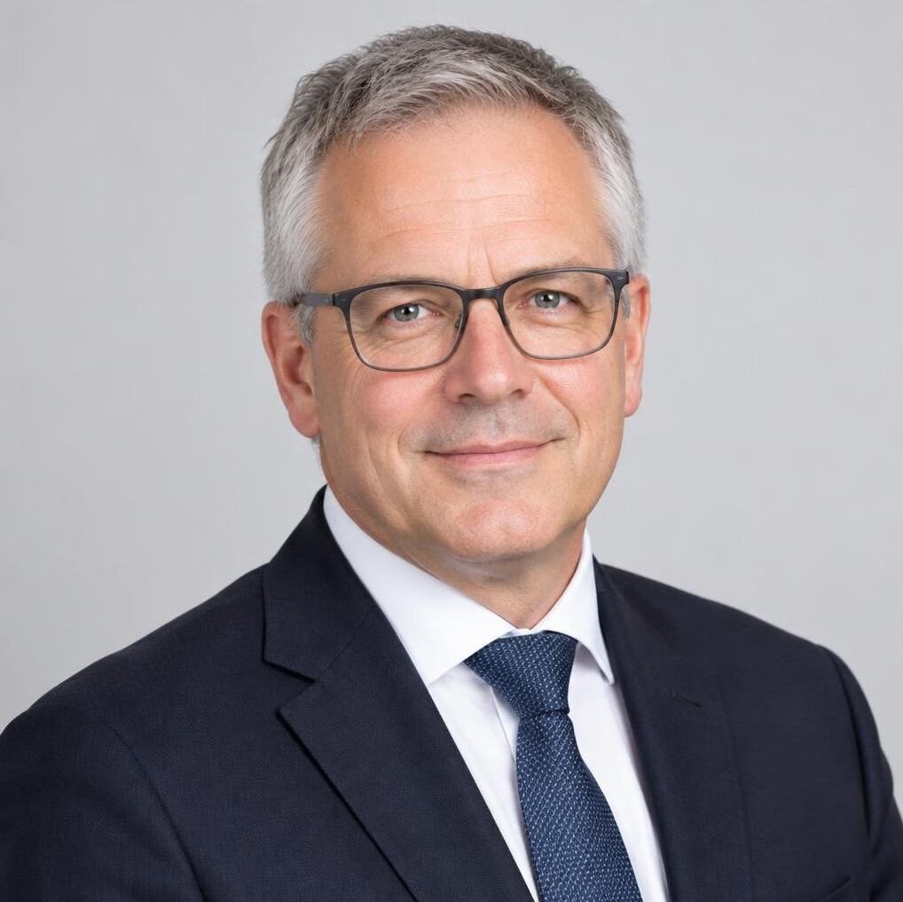 Studio portrait of a Belgian businessman in his 50s with glasses